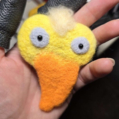 a yellow felted duck in my hand;